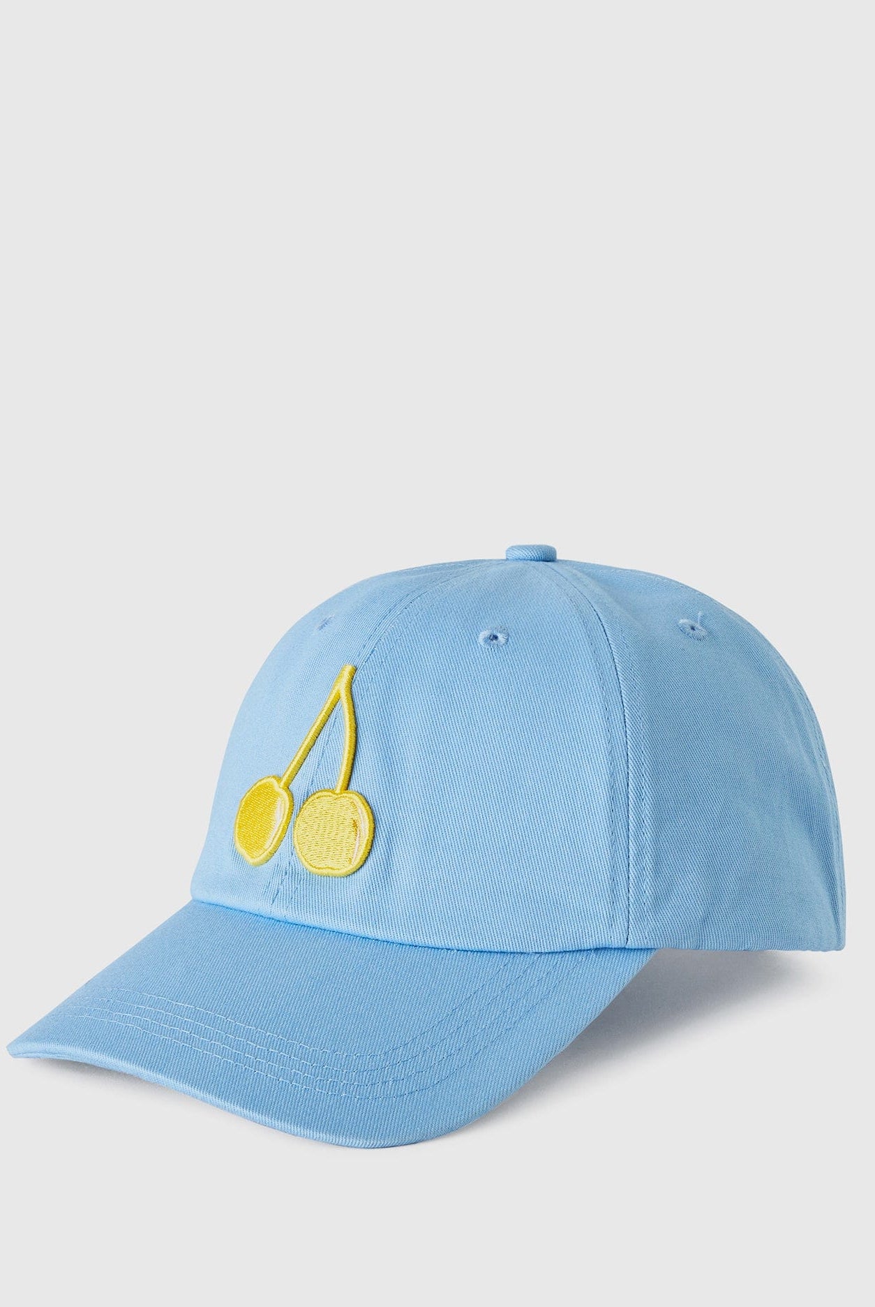 يونايتد كولورز اوف بينيتون كاب بتطريز فواكه بحافة مقوسة