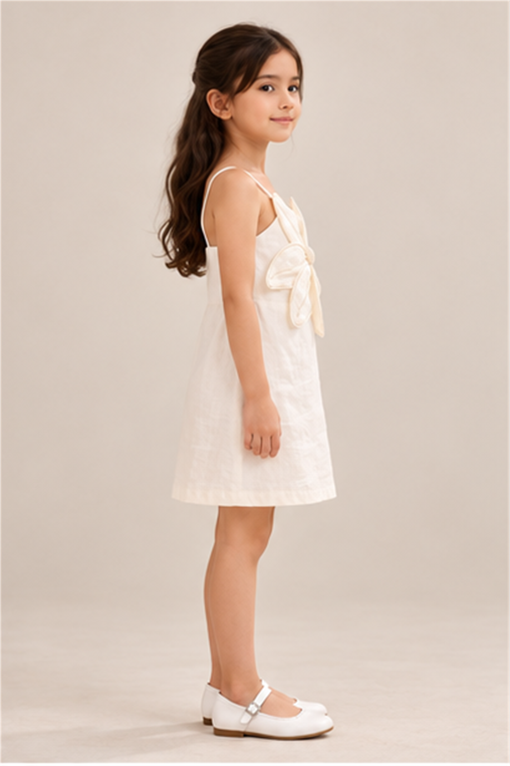 Girls' ivory flower-applique dress on child model, left side view