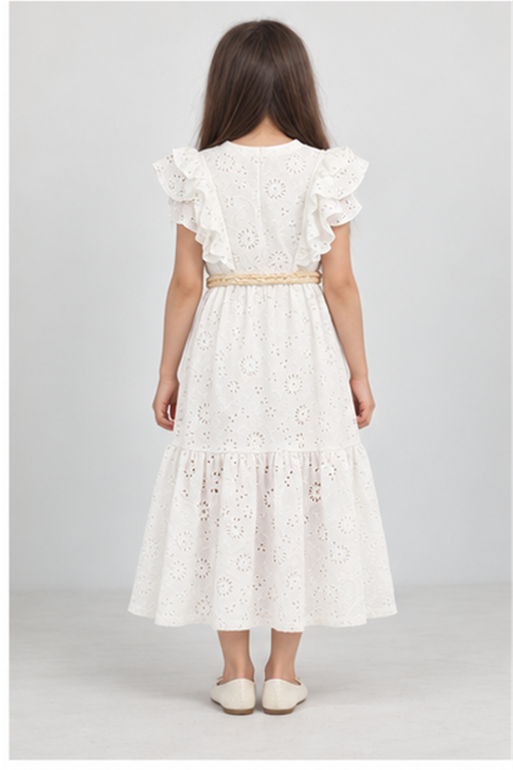 Girls' long white eyelet dress with rosette belt on child model, back view