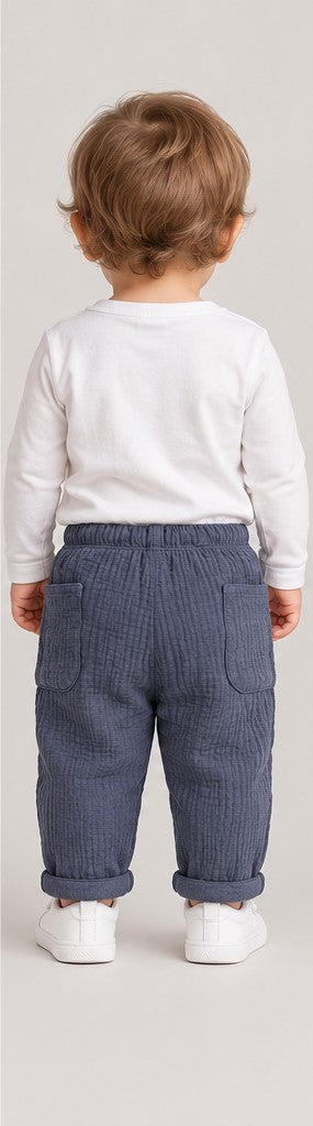 Back view of boys' slate blue quilted baby trousers on a toddler boy