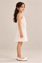 Girls' ivory flower-applique dress on child model, left side view