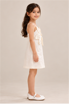 Girls' ivory flower-applique dress on child model, right side view