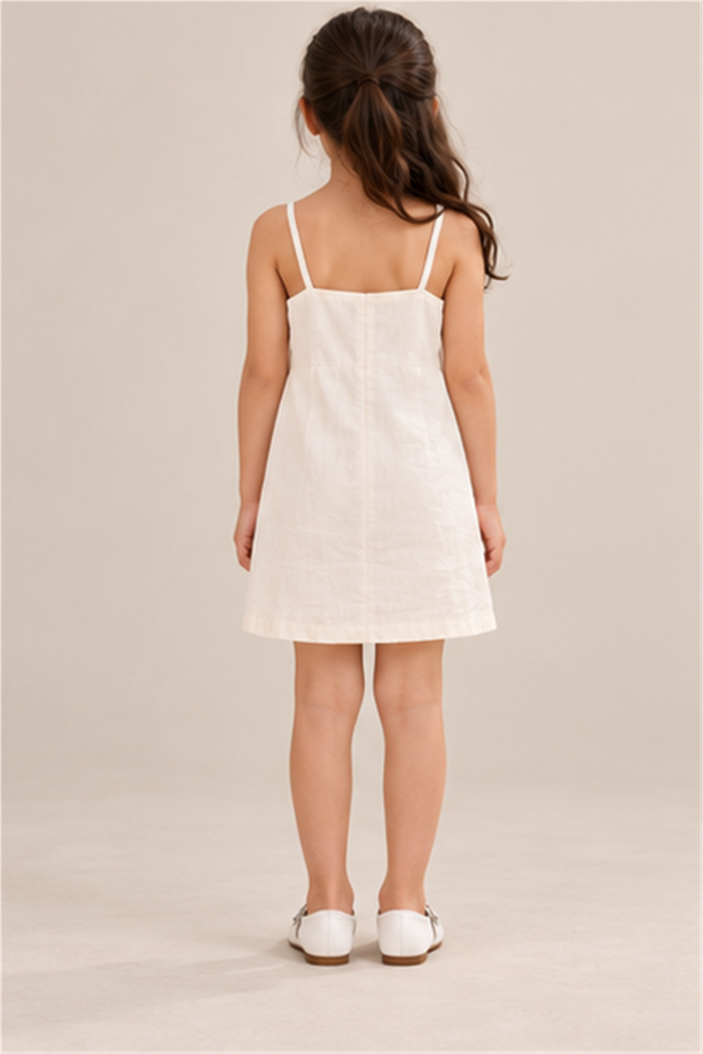 Girls' ivory flower-applique dress on child model, back view