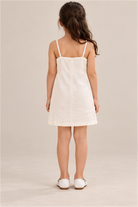 Girls' ivory flower-applique dress on child model, back view