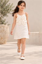 Girls' ivory flower-applique dress on child model, lifestyle view