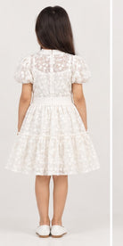 Girl model back view wearing Gingersnaps white embroidered tiered dress