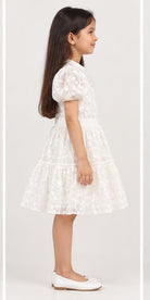 Girl model right view wearing Gingersnaps white embroidered tiered dress