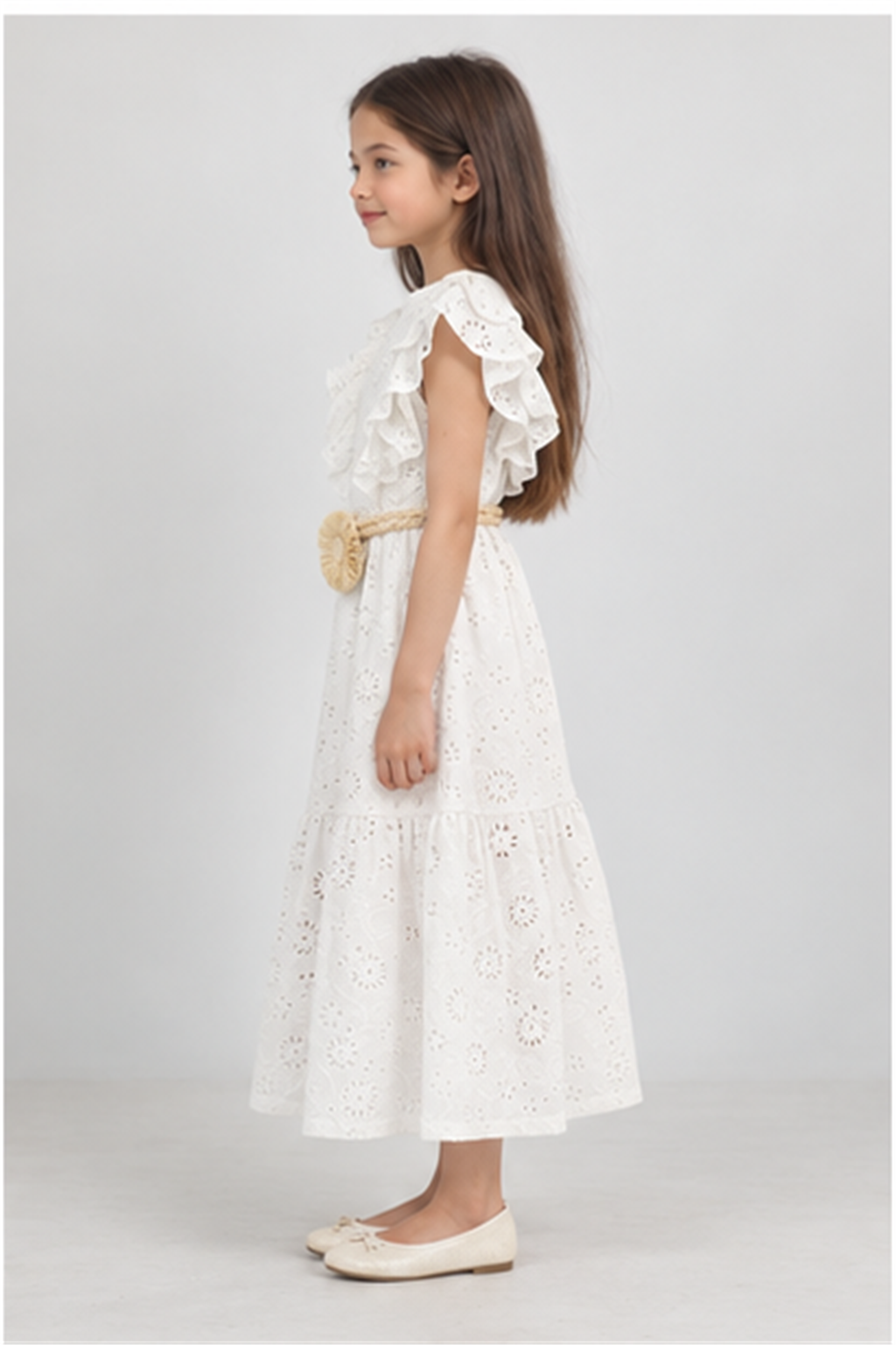 Girls' long white eyelet dress with rosette belt on child model, left side view