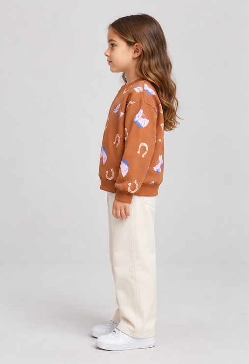 Child model wearing horse-print terracotta sweatshirt, left-side view