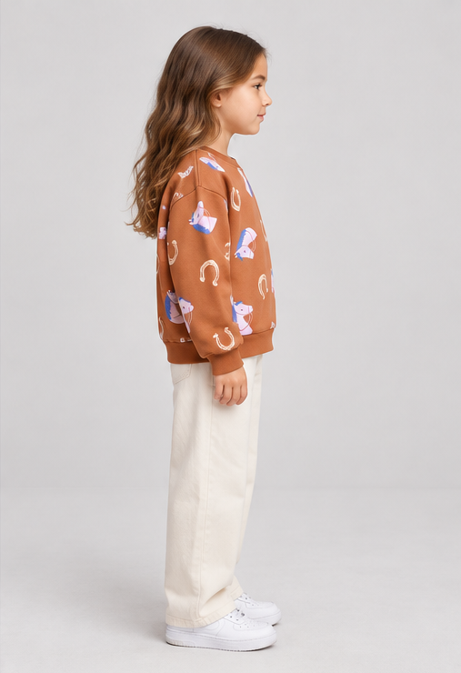 Child model wearing horse-print terracotta sweatshirt, right-side view