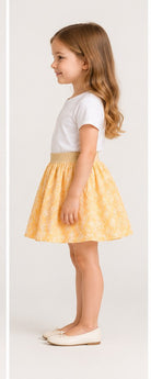Girls model left view wearing Gingersnaps yellow embroidered skirt