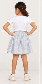 Girls model back view wearing Gingersnaps pale blue floral skirt