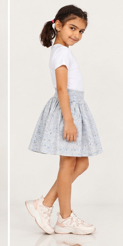 Girls model left view wearing Gingersnaps pale blue floral skirt