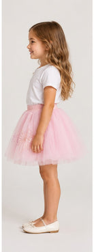 Girls model right view wearing Gingersnaps pale pink tulle skirt with embroidered motifs