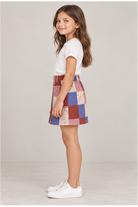 Girls' patchwork plaid skirt on child model, left side view
