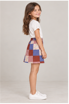Girls' patchwork plaid skirt on child model, right side view