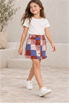 Girls' patchwork plaid skirt on child model, lifestyle view