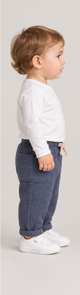 Left side view of boys' slate blue quilted baby trousers on a toddler boy