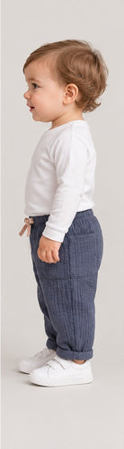 Right side view of boys' slate blue quilted baby trousers on a toddler boy