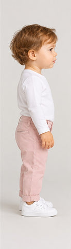 Left side view of boys' pale pink infant chinos with folded cuffs on an infant boy