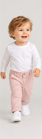 Lifestyle view of boys' pale pink infant chinos with folded cuffs on an infant boy