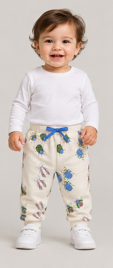 Front view of boys' ivory insect print baby joggers on an infant boy