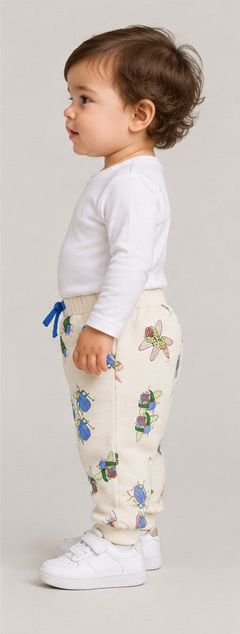 Right side view of boys' ivory insect print baby joggers on an infant boy