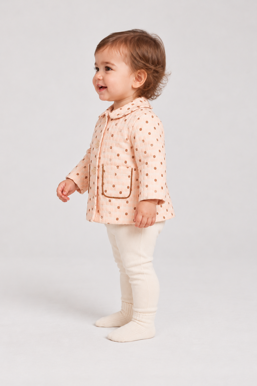 Left side baby girl model view of Gingersnaps dotted jacket