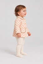 Right side baby girl model view of Gingersnaps dotted jacket