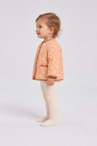 Left side baby model view of Gingersnaps printed infant jacket